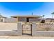 Modest single-story home featuring a gravel front yard and gated block fence at 5902 W Orange Dr, Glendale, AZ 85301