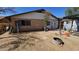 The backyard featuring a patio cover, partial landscaping with dirt, and potential for creative outdoor living at 604 W Emelita Ave, Mesa, AZ 85210