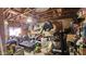 Cluttered garage space filled with tools, equipment, and various household items awaiting cleanup and organization at 604 W Emelita Ave, Mesa, AZ 85210