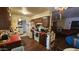 Functional kitchen with wooden cabinets, white appliances, and red countertops, adjacent to dining and living areas at 604 W Emelita Ave, Mesa, AZ 85210