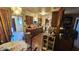 A kitchen with brown cabinetry, red countertops, and an open view to the dining area with tile floor at 604 W Emelita Ave, Mesa, AZ 85210