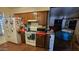 A practical kitchen featuring dark wood cabinets, red countertops, and modern appliances for functionality at 604 W Emelita Ave, Mesa, AZ 85210
