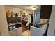 Practical laundry area with shelving and a modern washing machine next to an open doorway to the kitchen at 604 W Emelita Ave, Mesa, AZ 85210