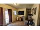 Cozy living room with tile floors, a large screen television, and natural light from the door to the outside at 604 W Emelita Ave, Mesa, AZ 85210