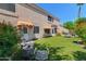 Landscaped backyard features low maintenance turf, seating area, and mature trees at 67 W Sarah Ln, Tempe, AZ 85284