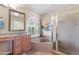 Bright bathroom with a soaking tub, glass shower, and a large window at 67 W Sarah Ln, Tempe, AZ 85284