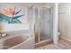 Stylish bathroom with a soaking tub, glass shower, and modern tile at 67 W Sarah Ln, Tempe, AZ 85284