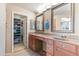 Bright bathroom with double vanity, decorative mirrors, and walk-in closet at 67 W Sarah Ln, Tempe, AZ 85284