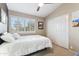 Bright bedroom features neutral walls, a large window with shutters, and a white comforter at 67 W Sarah Ln, Tempe, AZ 85284