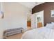 Bedroom featuring a partial bed, seating bench, and a door leading to a bathroom at 67 W Sarah Ln, Tempe, AZ 85284