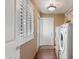 Laundry room with washer, dryer, wood floors and door to the exterior at 67 W Sarah Ln, Tempe, AZ 85284
