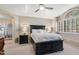 Bright main bedroom featuring a ceiling fan, dark furniture, and shuttered windows at 67 W Sarah Ln, Tempe, AZ 85284