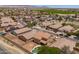 Aerial view of neighborhood featuring single-Gathering homes, some with solar panels, and desert landscaping at 6944 S Morning Dew Ln, Buckeye, AZ 85326