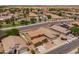 Aerial view of neighborhood featuring single-Gathering homes with pools, desert landscaping and city views at 6944 S Morning Dew Ln, Buckeye, AZ 85326
