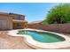 Backyard with covered patio overlooks a pool, perfect for outdoor enjoyment at 6944 S Morning Dew Ln, Buckeye, AZ 85326