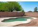 Enjoy the private pool in this spacious backyard with block fencing and mature trees at 6944 S Morning Dew Ln, Buckeye, AZ 85326