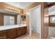 Bathroom with a mirror, a vanity with cabinet storage, and an adjacent toilet at 6944 S Morning Dew Ln, Buckeye, AZ 85326