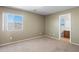 Bedroom with carpet and a window, alongside an open doorway to an attached bathroom at 6944 S Morning Dew Ln, Buckeye, AZ 85326