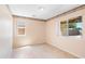 Bright bedroom with neutral walls, tile flooring, two windows providing lots of natural light, and decorative trim at 6944 S Morning Dew Ln, Buckeye, AZ 85326