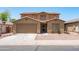 Two-story home boasts desert landscaping, a neutral color palette, and an attached two car garage at 6944 S Morning Dew Ln, Buckeye, AZ 85326