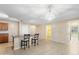 Bright kitchen and dining area with tile floors, a breakfast bar with seating, and access to other rooms at 6944 S Morning Dew Ln, Buckeye, AZ 85326