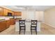 Kitchen with a center island, ample cabinet space, and tile floors at 6944 S Morning Dew Ln, Buckeye, AZ 85326