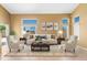 Staged living room with neutral walls, tile flooring, and comfortable seating with decor at 6944 S Morning Dew Ln, Buckeye, AZ 85326