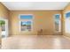 Bright living space features neutral walls, tile flooring, and many windows overlooking the backyard at 6944 S Morning Dew Ln, Buckeye, AZ 85326