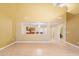 Open living space with tile flooring and neutral walls, featuring a view into the kitchen and access to other rooms at 6944 S Morning Dew Ln, Buckeye, AZ 85326
