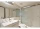 Bright bathroom featuring a sleek vanity, framed mirror, and a glass enclosed shower at 7625 E Camelback Rd # B226, Scottsdale, AZ 85251