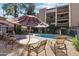 Relaxing pool area with lounge chairs, tables, and umbrellas, perfect for enjoying sunny days at 7625 E Camelback Rd # B226, Scottsdale, AZ 85251