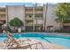 Inviting community pool with lounge chairs and well-maintained landscaping, offering a relaxing escape at 7625 E Camelback Rd # B226, Scottsdale, AZ 85251