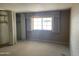 Cozy bedroom with a large window, providing ample natural light and closet space for storage at 7637 E Thornwood Dr, Scottsdale, AZ 85251