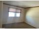 Bedroom featuring neutral walls and a large window at 7637 E Thornwood Dr, Scottsdale, AZ 85251