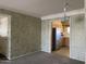 Dining room with vintage wallpaper adjacent to the kitchen at 7637 E Thornwood Dr, Scottsdale, AZ 85251