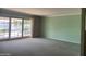 Bright living room featuring sliding glass doors and original details offering a seamless connection to the outdoors at 7637 E Thornwood Dr, Scottsdale, AZ 85251