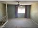 Spacious living room featuring a window and curtains, plus patterned wallpaper at 7637 E Thornwood Dr, Scottsdale, AZ 85251