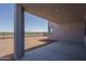 Covered outdoor porch overlooking a spacious yard with desert plants and block wall at 7956 W Griswold Rd, Peoria, AZ 85345
