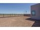 Spacious dirt backyard with privacy wall and fencing and views to the surrounding neighborhood at 7956 W Griswold Rd, Peoria, AZ 85345