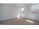 Bright bedroom with carpet, white walls, and well-placed windows for natural light at 7956 W Griswold Rd, Peoria, AZ 85345