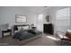 Cozy bedroom with an elegant framed print, side table, and chair bathed in natural light from two windows at 7956 W Griswold Rd, Peoria, AZ 85345