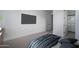 Bedroom with a large TV, walk-in shower and modern furnishings at 7956 W Griswold Rd, Peoria, AZ 85345