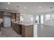 Open concept kitchen with a large island, modern faucet, and stainless steel appliances at 7956 W Griswold Rd, Peoria, AZ 85345