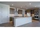 A contemporary kitchen boasts an island with bar seating, stainless steel appliances, and modern cabinetry at 7956 W Griswold Rd, Peoria, AZ 85345