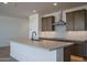 Bright kitchen with a large island, stainless steel hood, and neutral countertops at 7956 W Griswold Rd, Peoria, AZ 85345