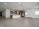 Open concept kitchen leading to Gathering room with center island and stylish finishes at 7956 W Griswold Rd, Peoria, AZ 85345