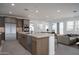 Modern kitchen featuring stainless steel appliances, island with sink, and open floor plan at 7956 W Griswold Rd, Peoria, AZ 85345