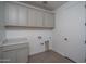 Laundry room with tile flooring, neutral cabinets, countertop, and essential hookups at 7956 W Griswold Rd, Peoria, AZ 85345
