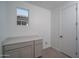 The laundry room features cabinets, counter space, and a convenient window for natural light at 7956 W Griswold Rd, Peoria, AZ 85345