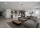 Open concept living room flowing to kitchen with a large sectional couch, dining table and chairs at 7956 W Griswold Rd, Peoria, AZ 85345